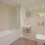 Modern bathroom with bathtub and toilet.