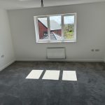 Empty room with window and grey carpet