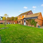 Brick house with spacious garden and patio.