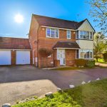Detached house with double garage in sunlight