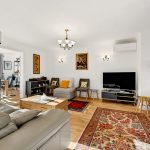 Modern living room with colourful decor and furniture.