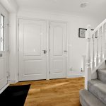 Modern hallway with staircase and wooden floor