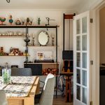 Dining room with shelves and table decoration.