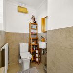 Modern bathroom with toilet and sink.