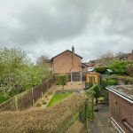 Suburban garden with cloudy sky backdrop.
