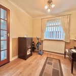 Cosy living room with wooden floor and window.