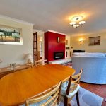 Spacious living room with dining area and sofa.