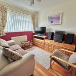 Comfortable living room with sofa and TV setup.