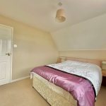 Cosy bedroom with double bed and side tables.