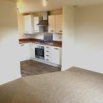 Modern kitchen with wooden worktops and appliances.