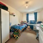 Cosy bedroom with toys and bed.