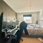 Bedroom with computer desk and double bed