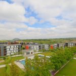 Modern residential complex with landscaped gardens and greenery.