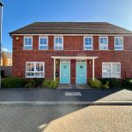 Modern brick semi-detached house with blue doors.