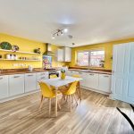 Bright kitchen with yellow accents and modern decor.