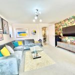 Colourful living room with floral wallpaper and modern decor.