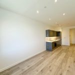 Modern kitchen in a spacious open-plan living area.