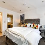 Modern bedroom with double bed and en-suite bathroom.
