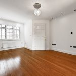 Empty modern room with wooden floor and chandelier