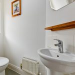 Modern bathroom with sink and toilet.