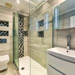 Modern bathroom with shower, toilet, and sink.
