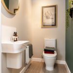 Modern bathroom with sink and toilet.