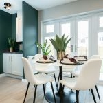 Modern dining area with green and white decor.