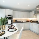 Modern kitchen with dining table and decor.