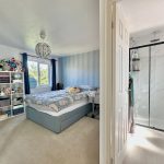 Cosy bedroom with ensuite bathroom and soft toys.