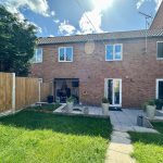 Backyard of brick house with patio area