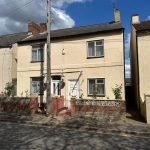 Two-storey terraced house with front garden.