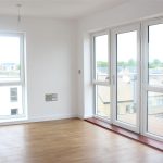 Bright room with wooden floor and large windows