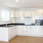 Modern white kitchen with wooden floor