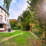 Sunny garden with patio and furniture