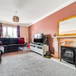Cosy living room with fireplace and TV.