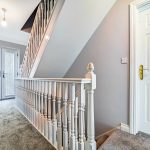 Modern hallway with staircase and French doors.