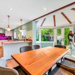 Modern kitchen-diner with bay windows and telescope.