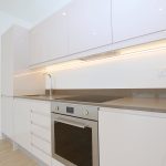 Modern white kitchen with built-in oven