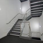 Modern staircase with metal railings in building interior.