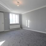 Empty grey room with window and carpet