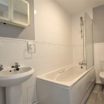 Modern bathroom with bathtub, sink, and toilet