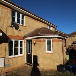 Brick house exterior with satellite dish and patio.