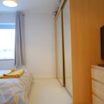 Modern bedroom with TV and mirrored wardrobe