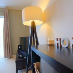 Modern living room with standing lamp and decor.