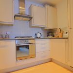 Modern kitchen with white cabinets and oven