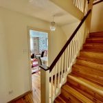 Wooden staircase and living room entryway.