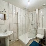 Modern tiled bathroom with shower and sink