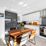 Modern kitchen with wooden table and chairs.