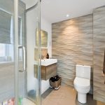 Modern bathroom with wave-patterned tiles.