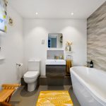 Modern bathroom with white and grey decor.